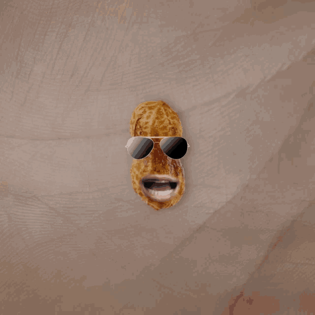 a peanut wearing sunglasses with the word win in green behind it