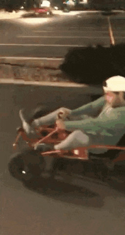 a blurry picture of a person laying on a bed in a car .