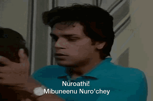a man in a blue shirt says nuroathi and mibuneenu nuro chey