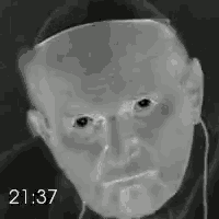 a black and white photo of a man 's face with the time 21:37