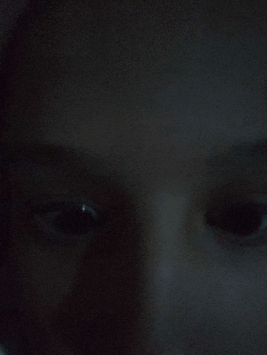 a close up of a person 's face with a black background