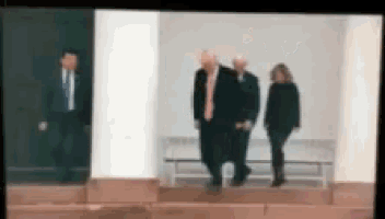 a blurry picture of a man and two women walking