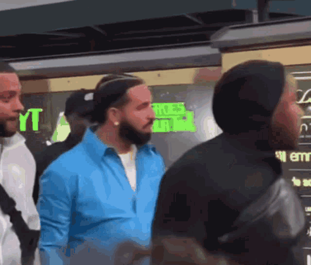 a group of men standing in front of a sign that says ' yt '