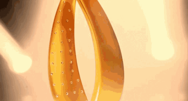 a close up of a gold object with rhinestones