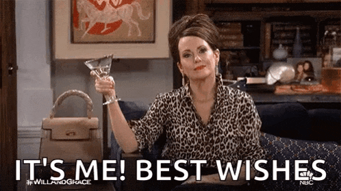 a woman is sitting on a couch holding a martini glass and saying `` it 's me best wishes '' .