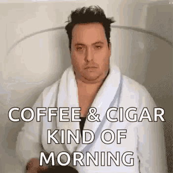 a man in a bathrobe is sitting in a bathtub with the words `` coffee & cigar kind of morning '' written on it .