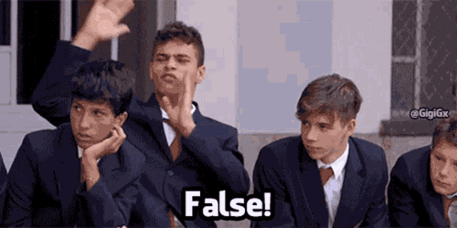 a group of boys are sitting in a classroom and one of them says " false "
