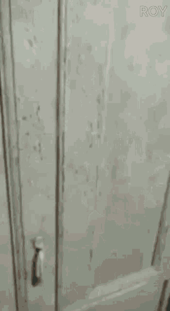 a person is knocking on a door with their hand .
