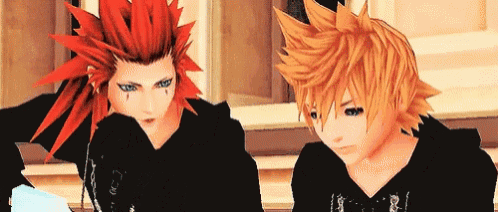 a couple of anime characters with red hair and yellow hair are sitting next to each other .