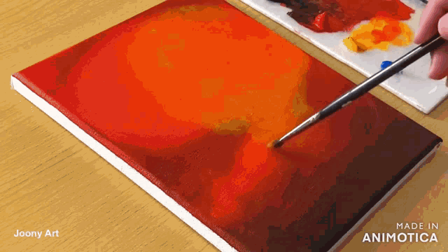 a painting is being painted with a brush and the words made in animotica are visible