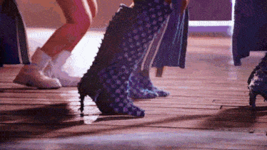 a close up of a person 's feet wearing a pair of spiked boots .