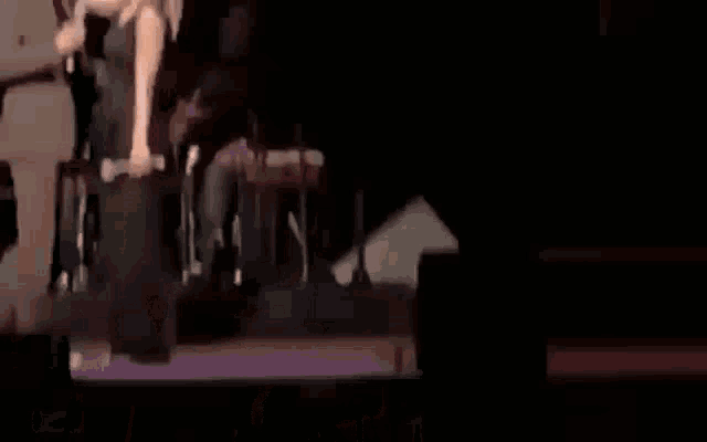 a man and a woman are standing on a stage talking to each other .