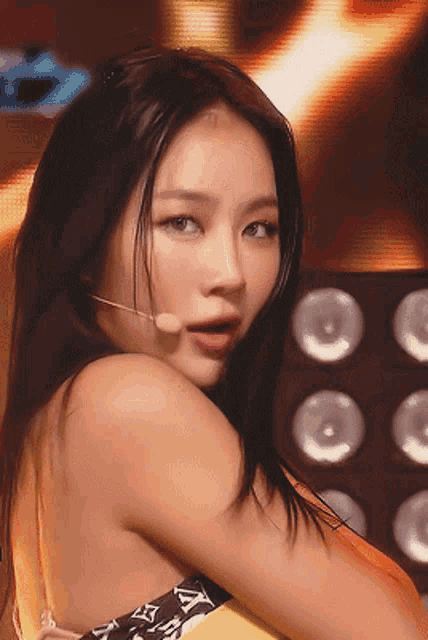 a close up of a woman 's face with a microphone