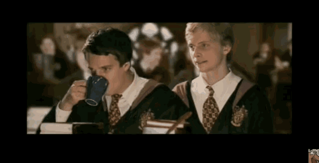 two boys in harry potter costumes are blowing smoke out of their mouths
