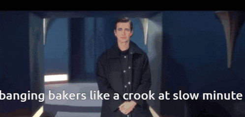 a man in a black jacket stands in a dark room with the words " banging bakers like a crook at slow minute "