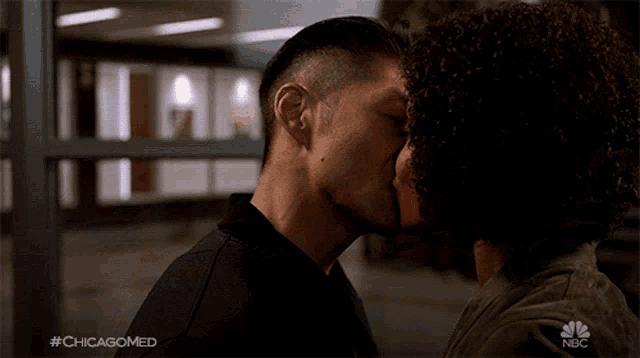 a man and a woman kissing with the hashtag #chicagomed
