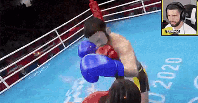 a man wearing headphones is watching a boxing match in a ring .