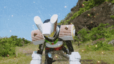 a robot is standing in a field with a mountain in the background and a blue sky