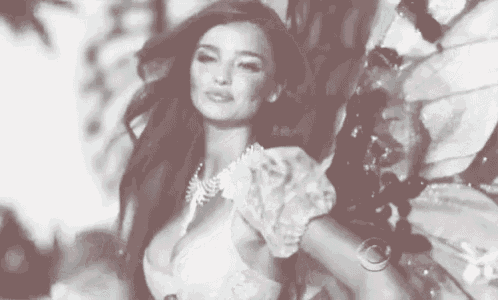 a black and white photo of a woman in a lace bra .