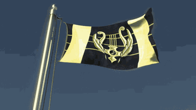 a black and yellow flag with a harp on it is flying in the wind