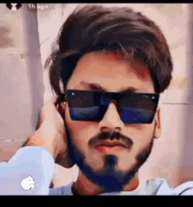 a man with a beard and sunglasses is taking a picture of himself .