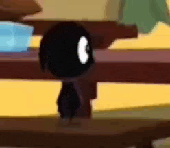a black cartoon character is standing on a wooden table .