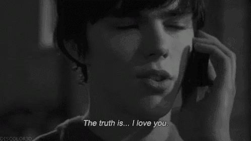 a man talking on a cell phone with the words " the truth is ... i love you " above him