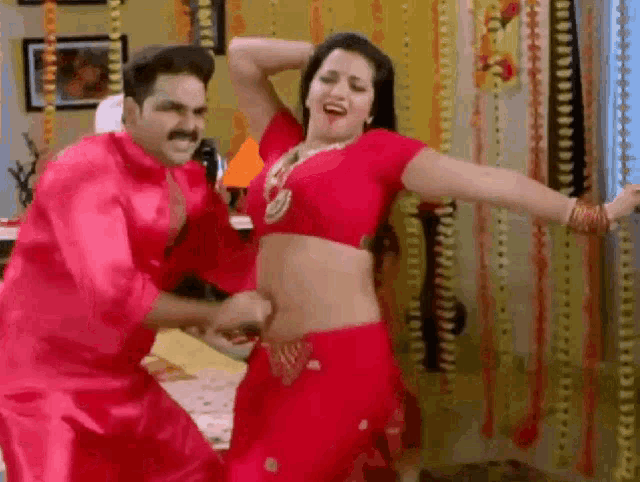 a man and a woman are dancing in a room .