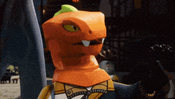 a lego figure with an orange head and yellow eyes is standing in a dark room