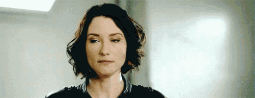 a close up of a woman 's face with short hair