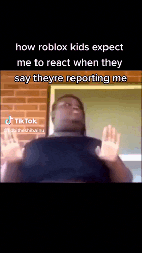 a man is standing in front of a brick wall with his hands up and says " how roblox kids expect me to react "