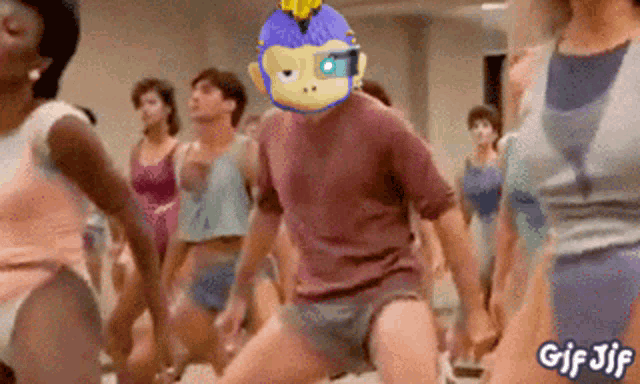 a group of people are dancing with a man wearing a mask with a monkey on it