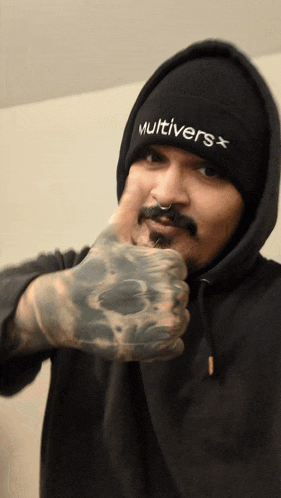 a man wearing a black beanie that says multiverse on it