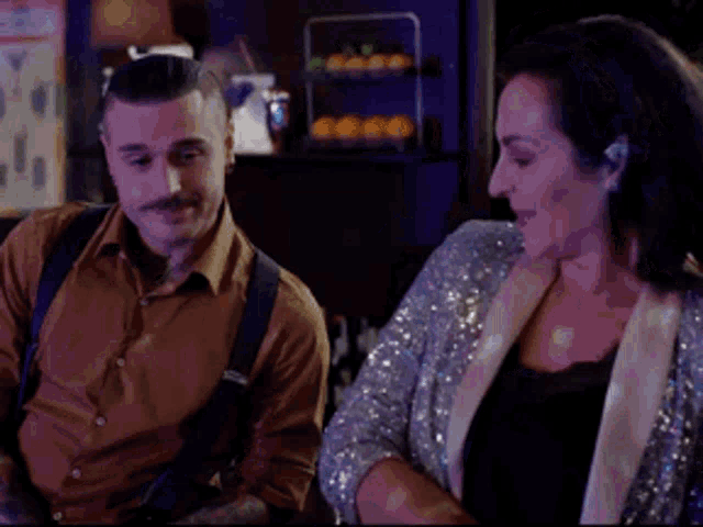 a man and a woman are standing next to each other