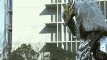a close up of a person in a superhero costume standing in front of a building .