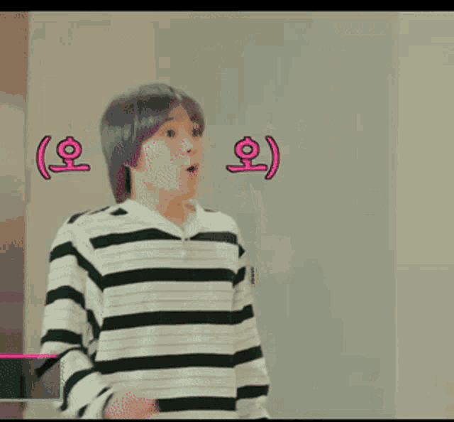 a boy with purple hair is wearing a striped shirt and has korean writing on his face