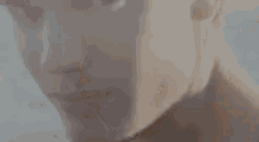 a close up of a woman 's face with a beard and a beard .