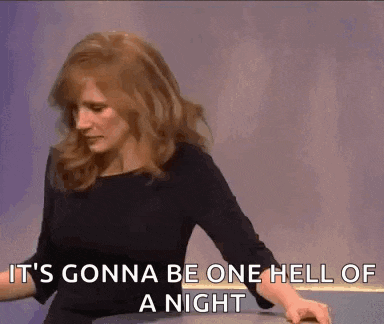 a woman is sitting at a table and says `` it 's gonna be one hell of a night ''