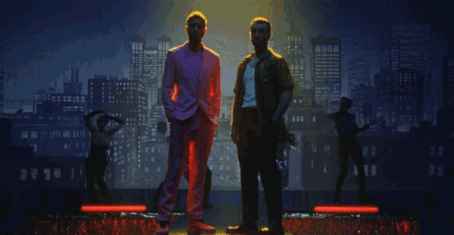 two men standing in front of a city skyline