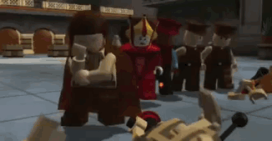 a group of lego figures standing around a fallen figure