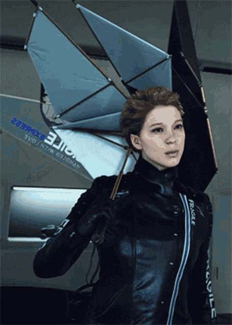 a woman holding an umbrella with the word fragile on her jacket