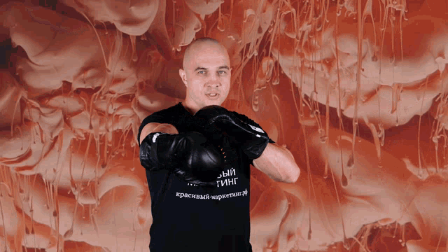 a man wearing boxing gloves and a black shirt that says ' a ' on it