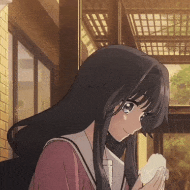 a girl with long black hair holds a piece of paper in her hand