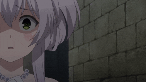 a close up of a girl 's face with a brick wall behind her