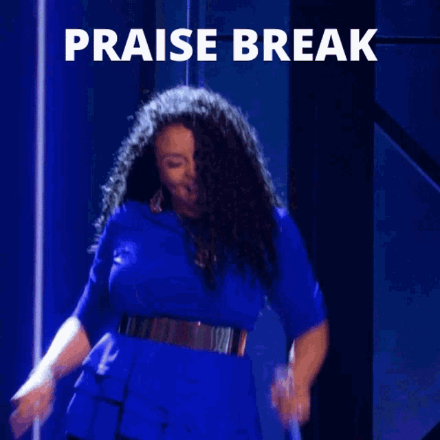 a woman in a blue dress is dancing in front of a sign that says " praise break "