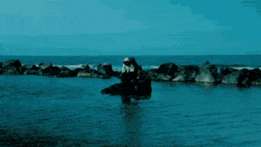 a person in a nun costume is standing in the ocean