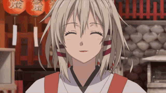 a girl with blonde hair is smiling in front of lanterns with chinese characters on them