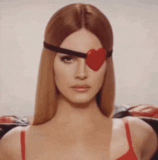 a woman wearing a red bra and a heart shaped eye patch