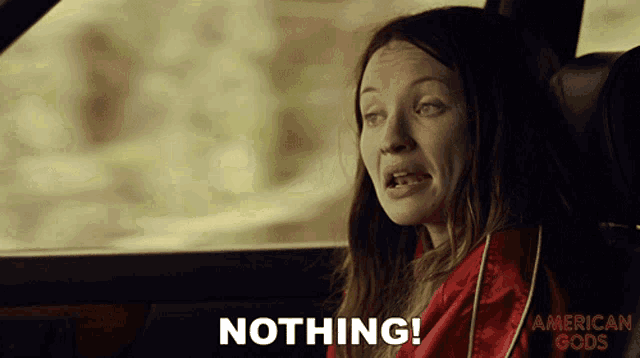 a woman sitting in a car with the words nothing on the bottom