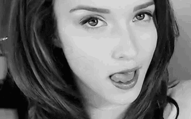 a close up of a woman 's face with her tongue out .
